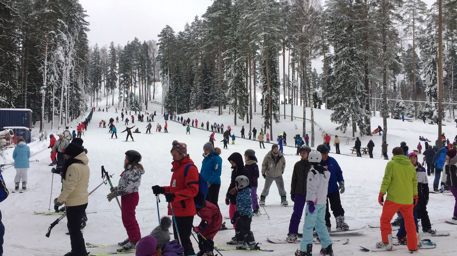 Riekstu Kalns in Latvia - a group of people skiing down a snowy hill.