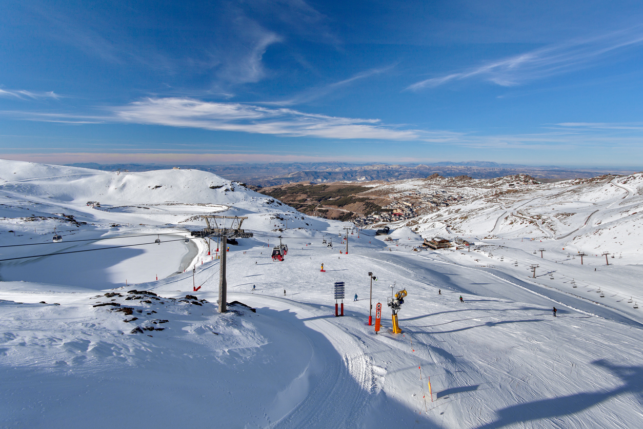Riekstu Kalns in Latvia - a group of people skiing down a snowy mountain.