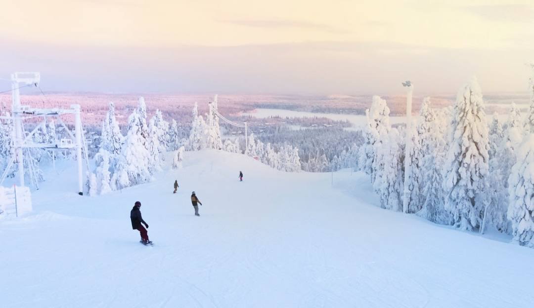 A lively winter sports scene at Sunrise Park in Arizona featuring a ski resort surrounded by stunning winter scenery. Skiers and snowboarders descend the slopes accessed by a ski lift.