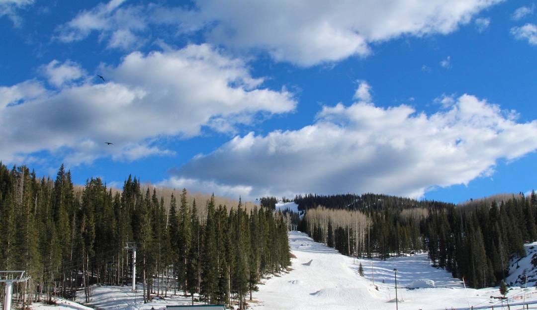 A picturesque winter scene at Sunrise Park Arizona a popular ski resort. The image features a ski lift ascending snow-covered slopes capturing the essence of exhilarating winter sports.