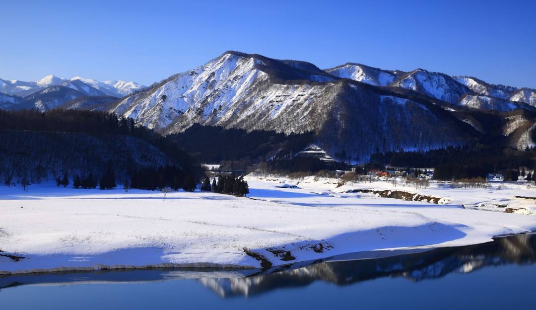 Spectacular winter view at Sunrise Park, Arizona featuring a bustling ski resort amidst stunning snowy scenery. The towering mountain in the backdrop adds elegance to the winter sports scene.