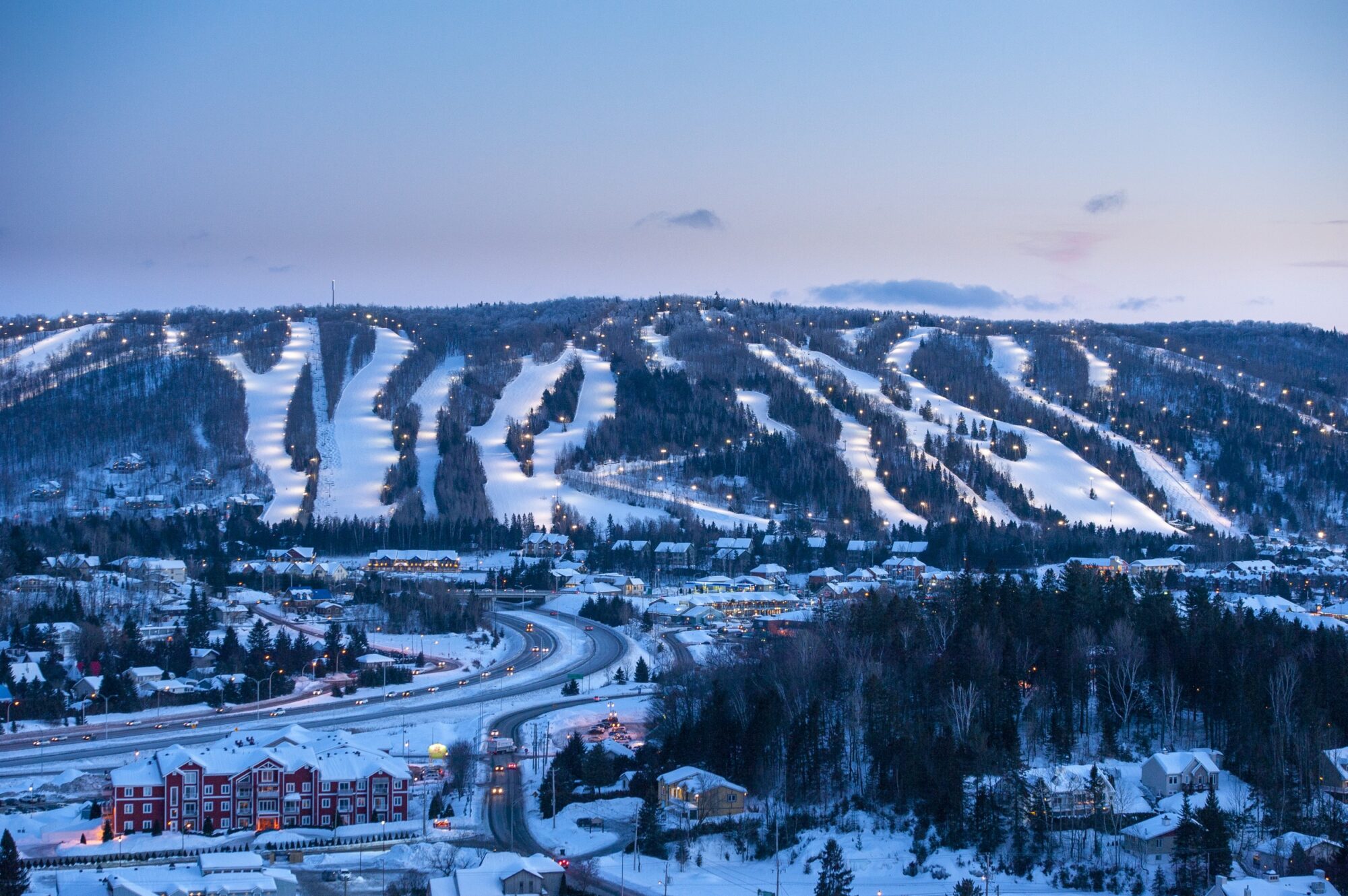 Sommet Saint-Sauveur in Canada: a view of a ski resort at dusk.