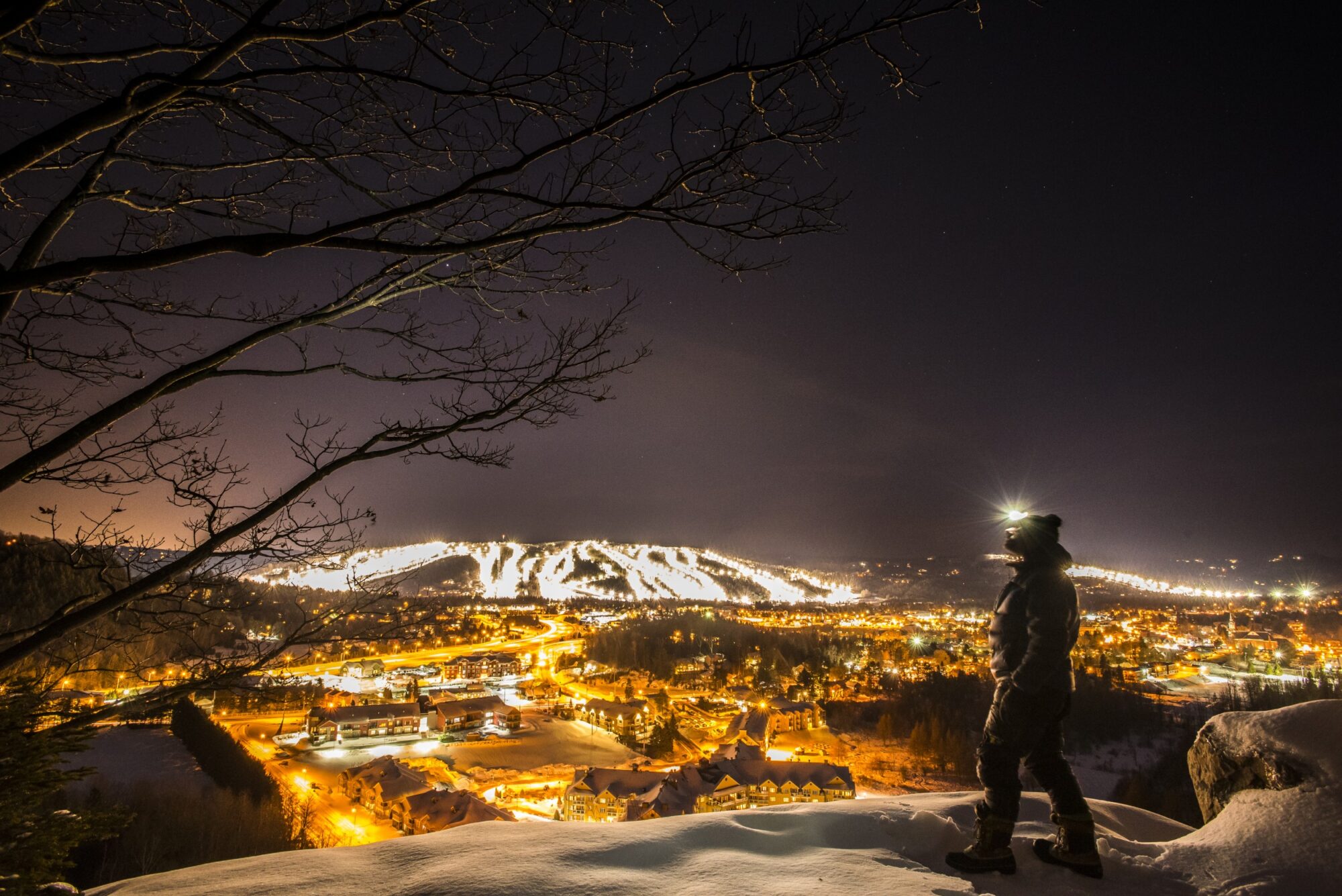 Sommet Saint-Sauveur in Canada - a person standing on top of a snow covered hill.