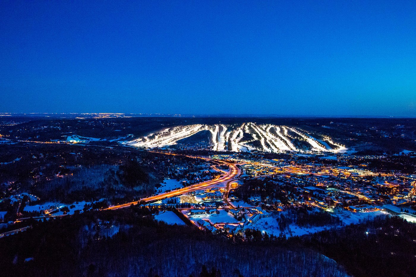 Sommet Saint-Sauveur in Canada - a view from the top of a mountain at night.