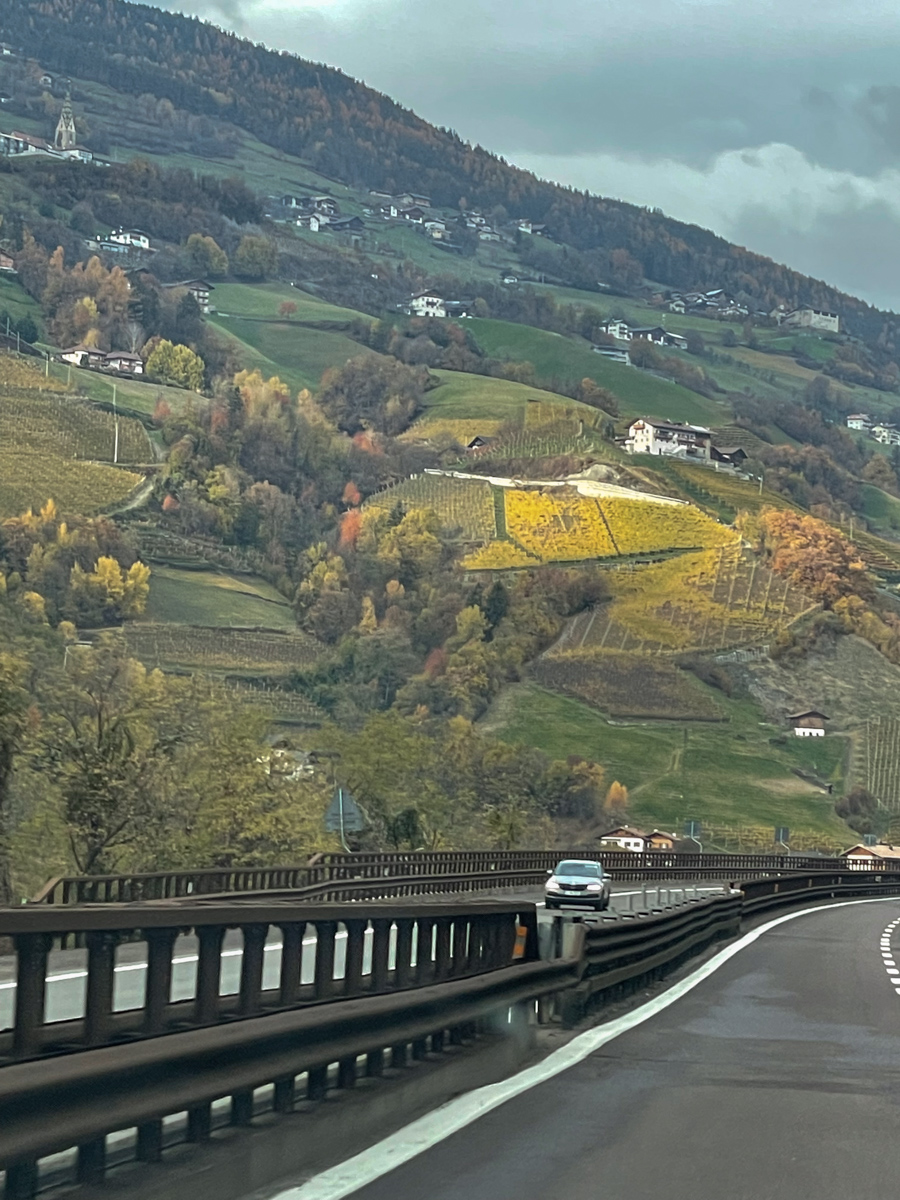 Sulden in Italy - a car driving down a road with hills in the background.