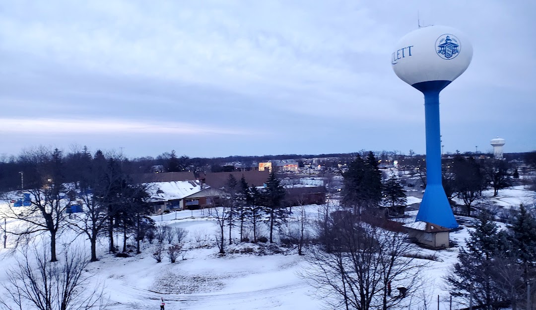 Winter sports scene at Villa Olivia, Bartlett, Illinois, featuring a bustling winter sports centre surrounded by a stunning snow-covered landscape, including a quaint chalet.