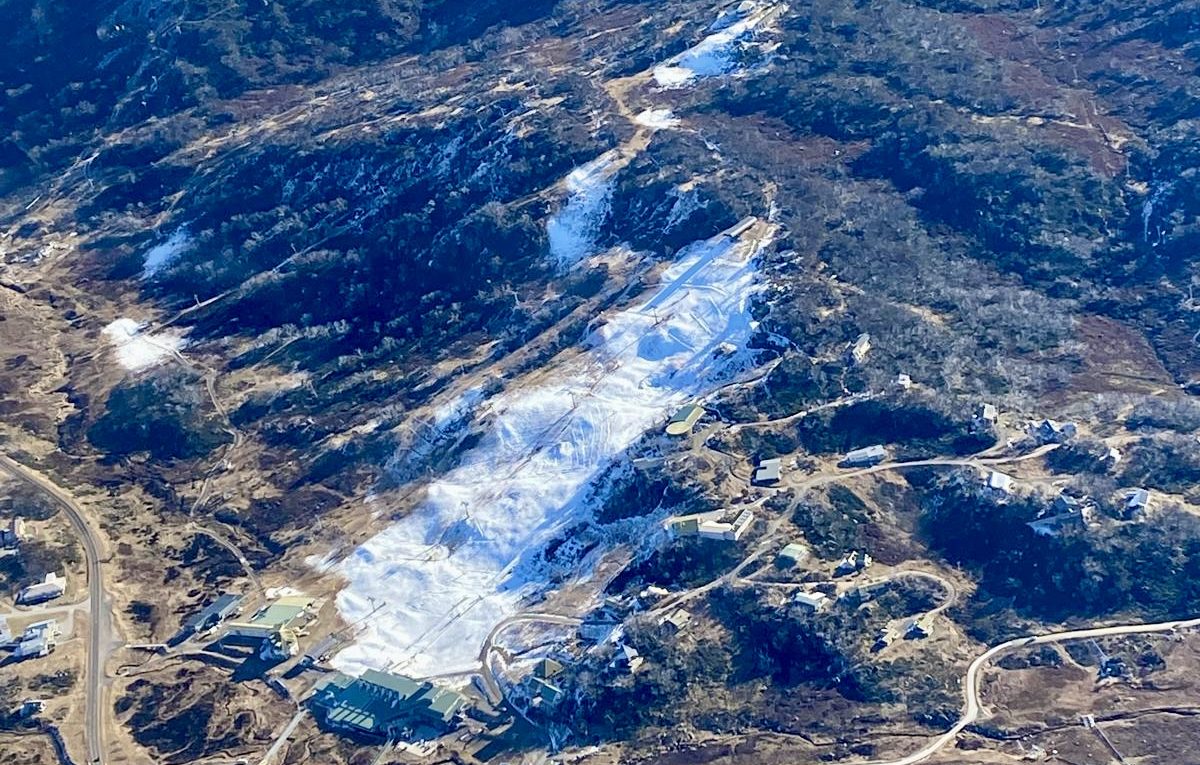 Perisher in Australia - an aerial view of a mountain with snow on the ground.