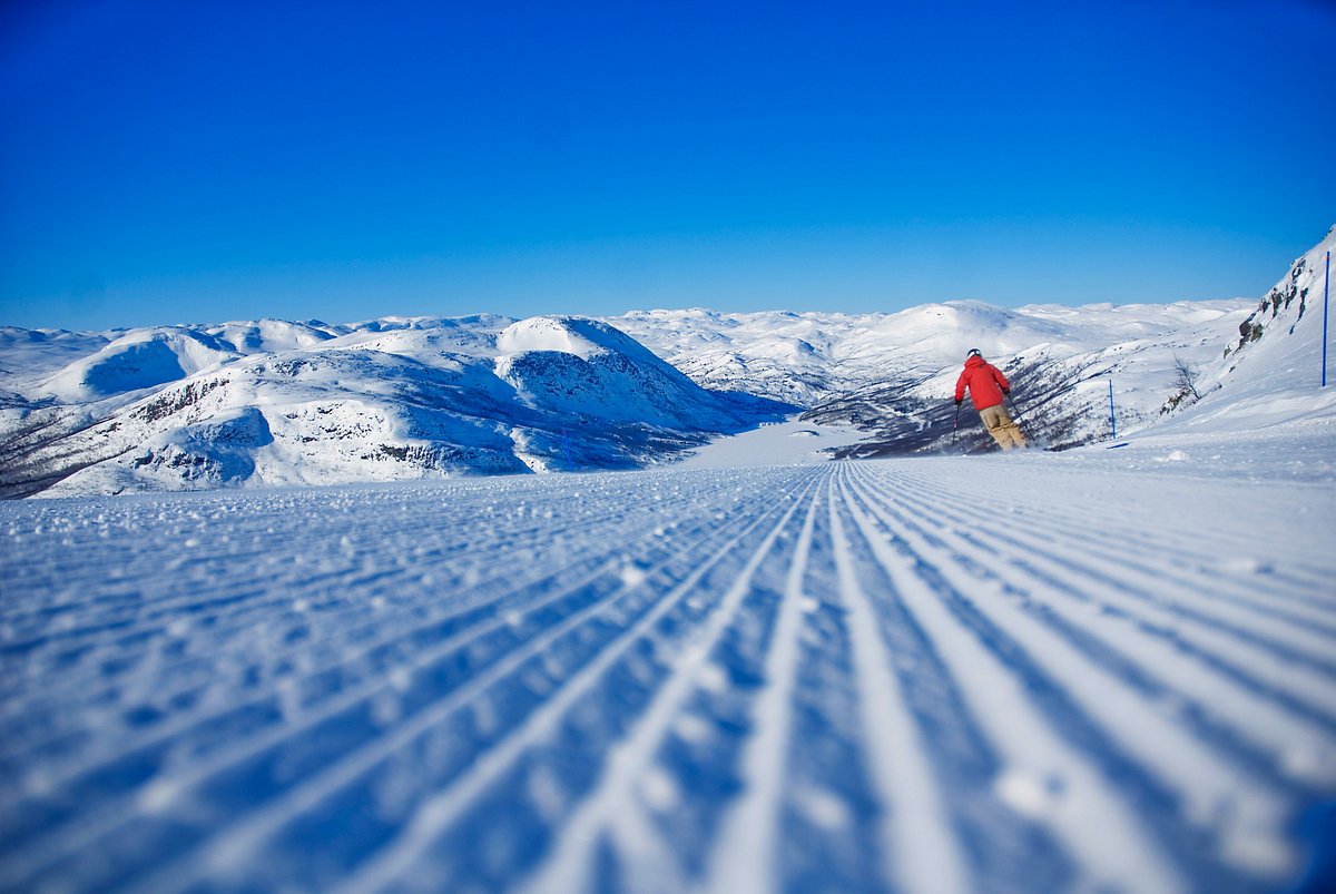 Hovden in Norway - a person skiing down a snow covered mountain.