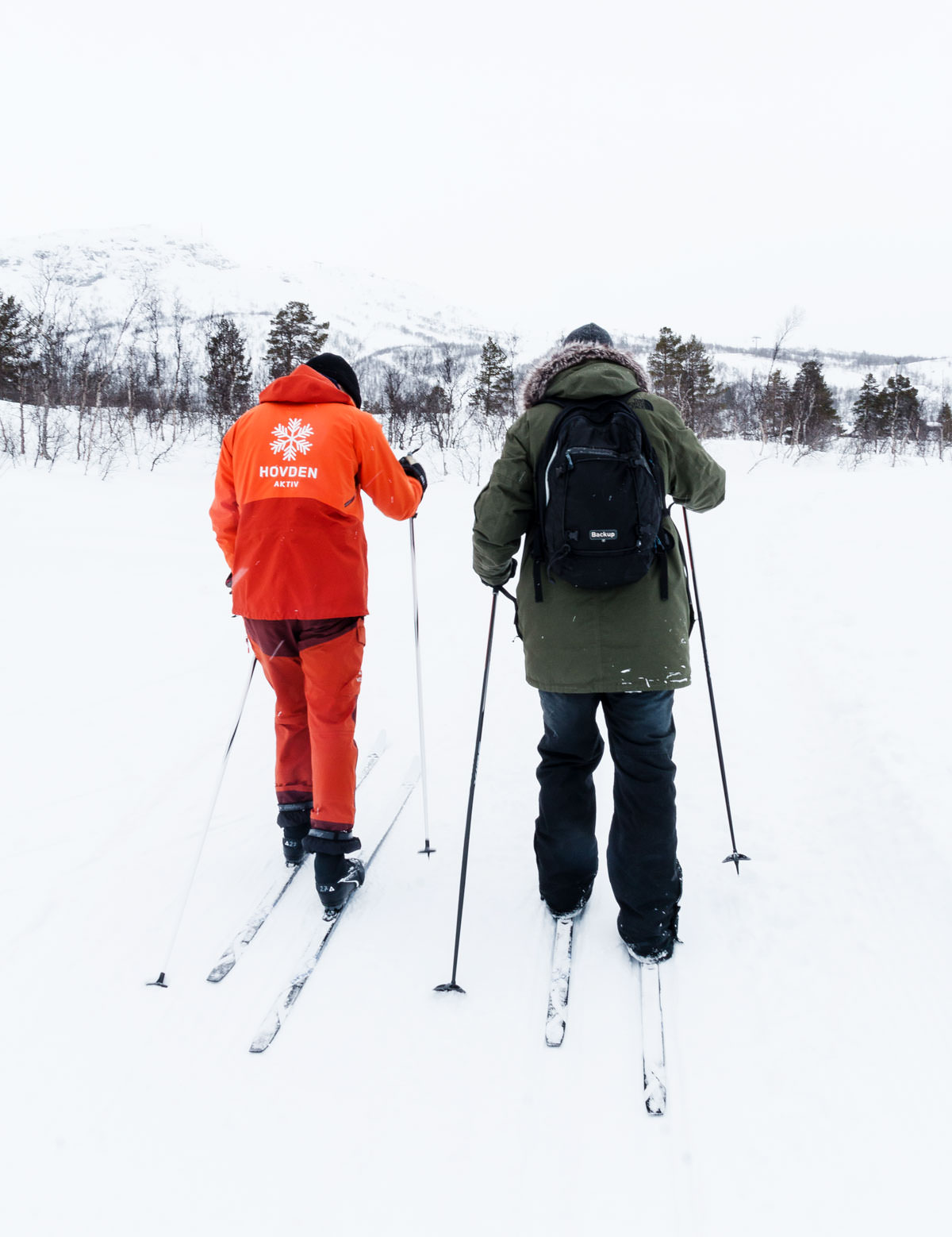 Hovden in Norway - two people are skiing down a snowy hill.