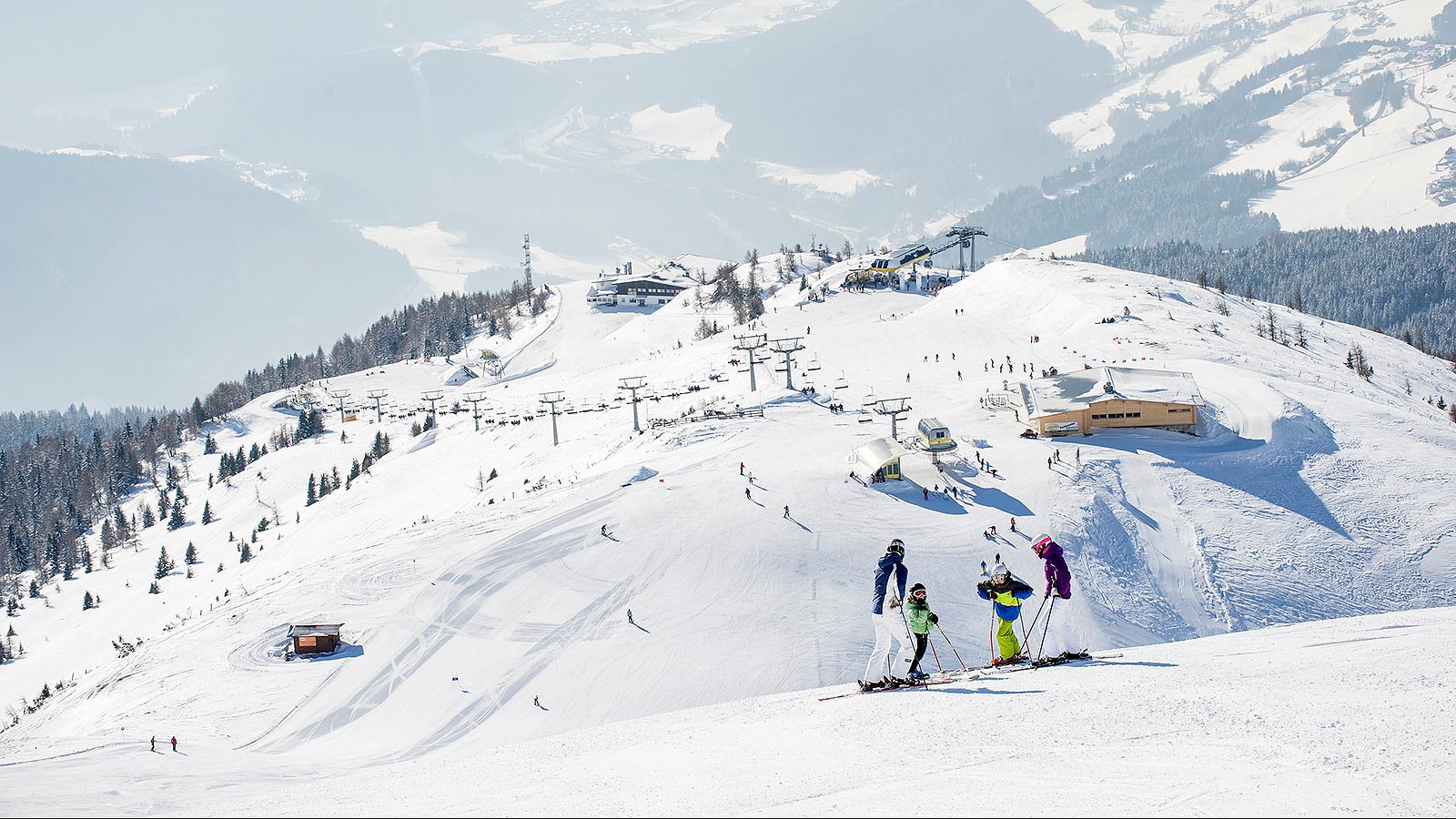 Gitschberg Jochtal in Italy - a group of people skiing down a snow covered mountain.