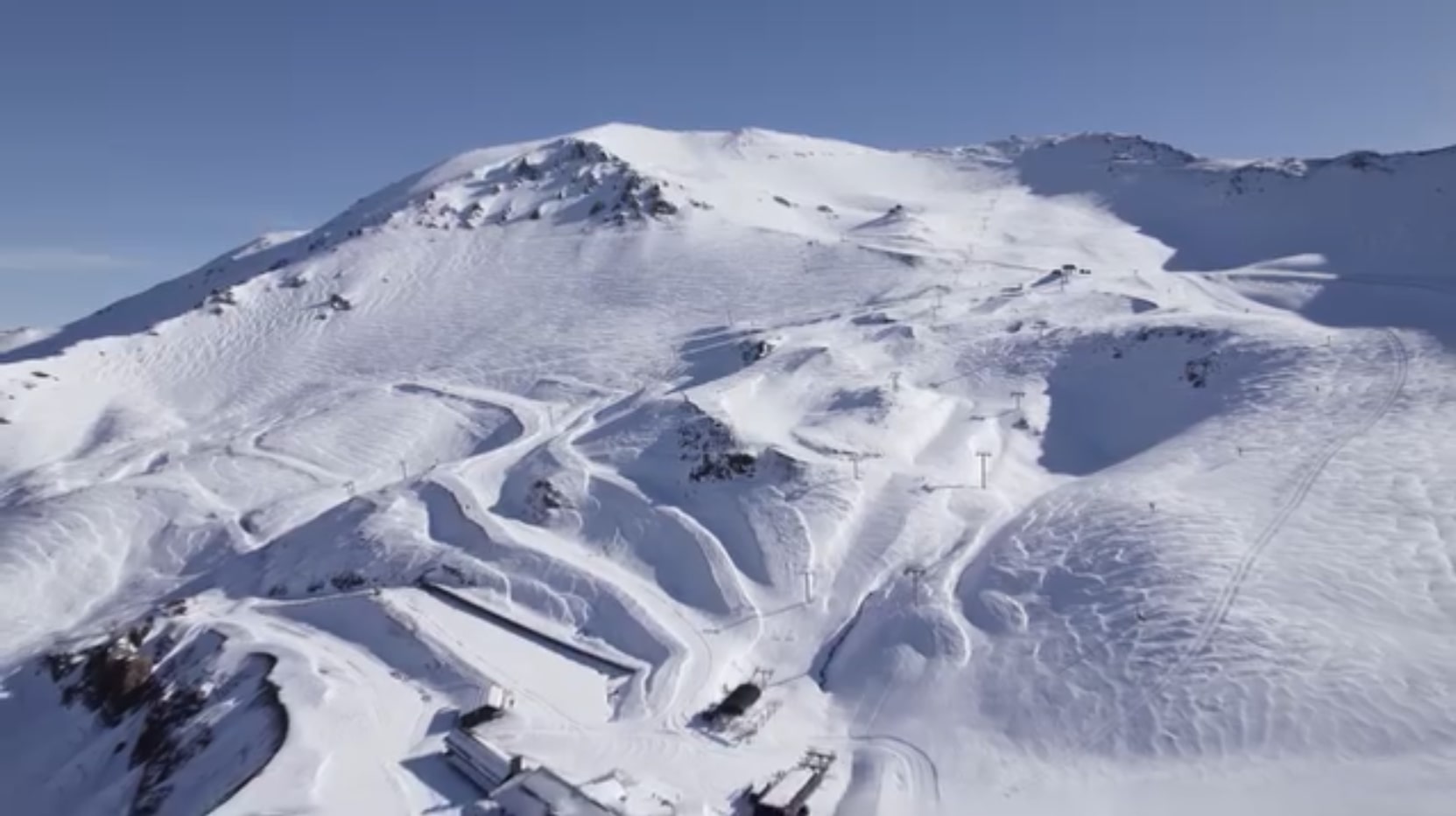 Mt Hutt in New Zealand - an aerial view of a mountain with snow on it.