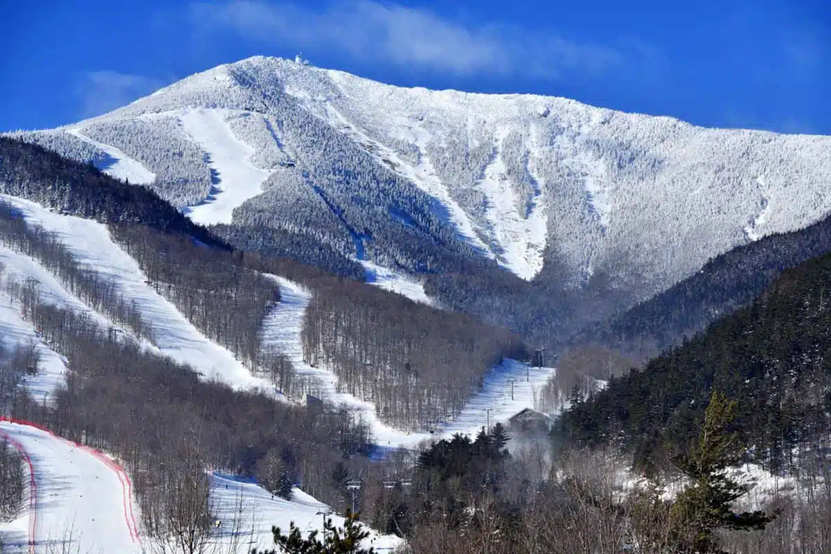 Whiteface mountain in USA - a snow covered mountain with trees in the fore.
