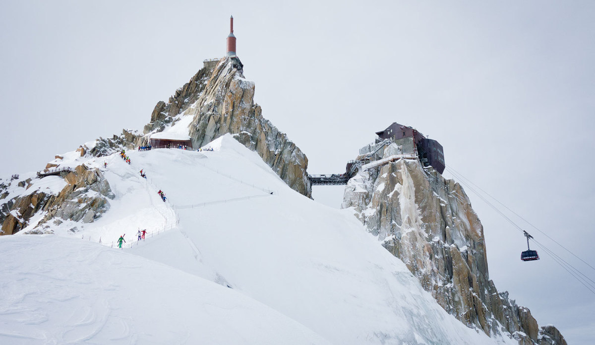 L'Aiguille du Midi in France - a group of people climbing up a snowy mountain.