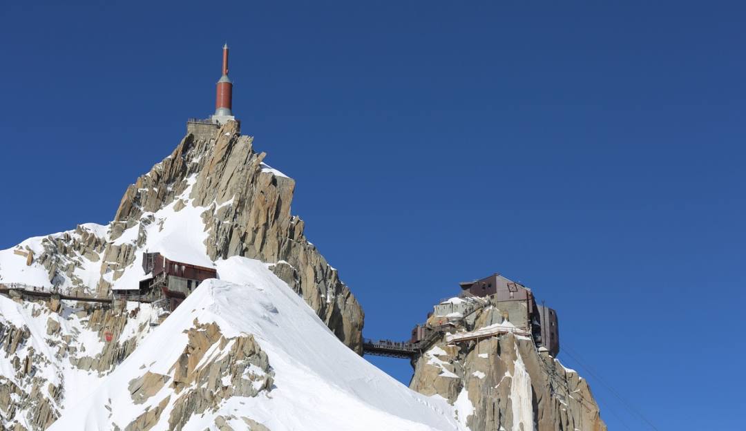 L'Aiguille du Midi in France - a snow covered mountain with a church on top.