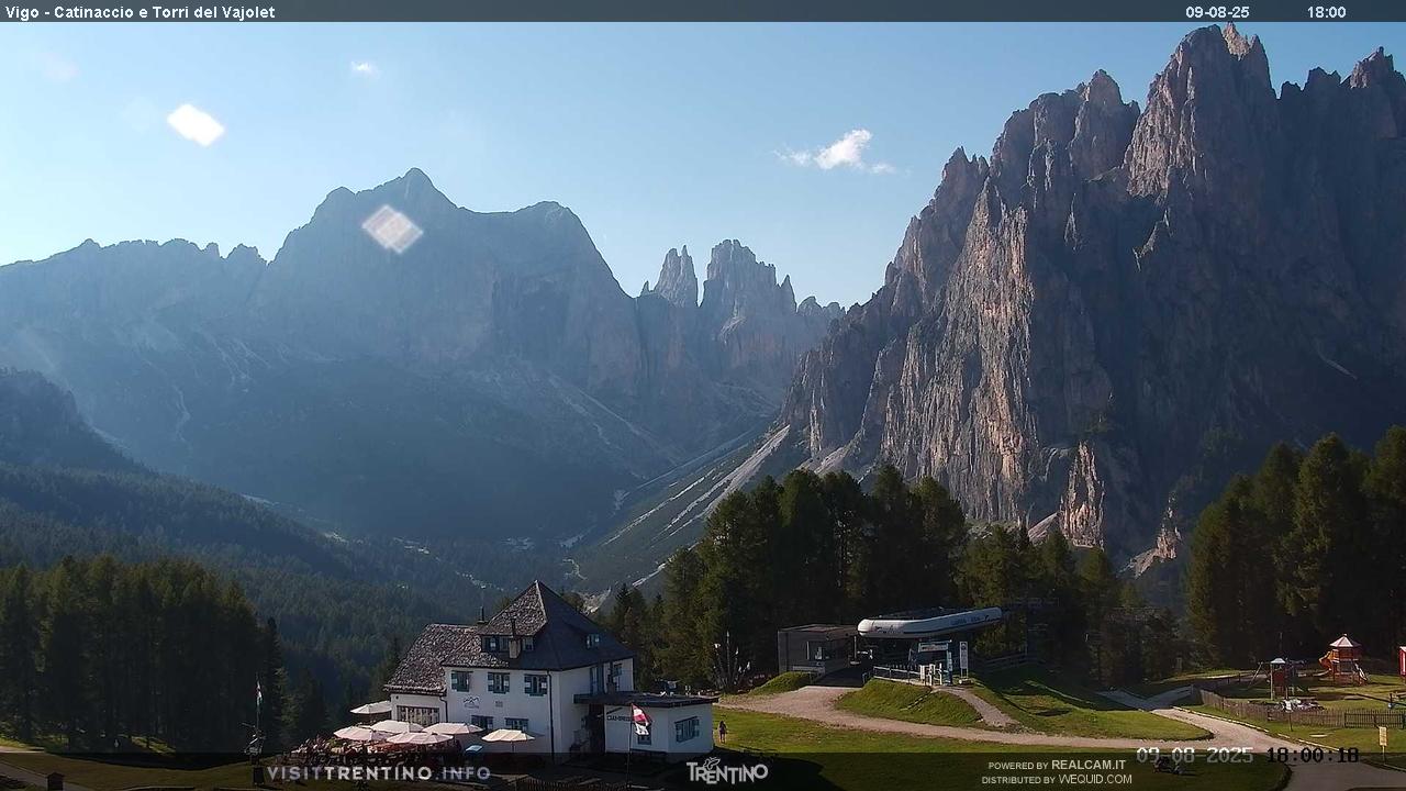 Catinaccio Ciampedie in Italy - the mountains are covered in clouds and trees.