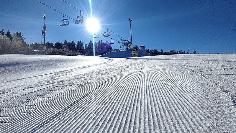 Fallbachhang – Oberhof in Germany - a ski slope with a ski lift going up the hill.