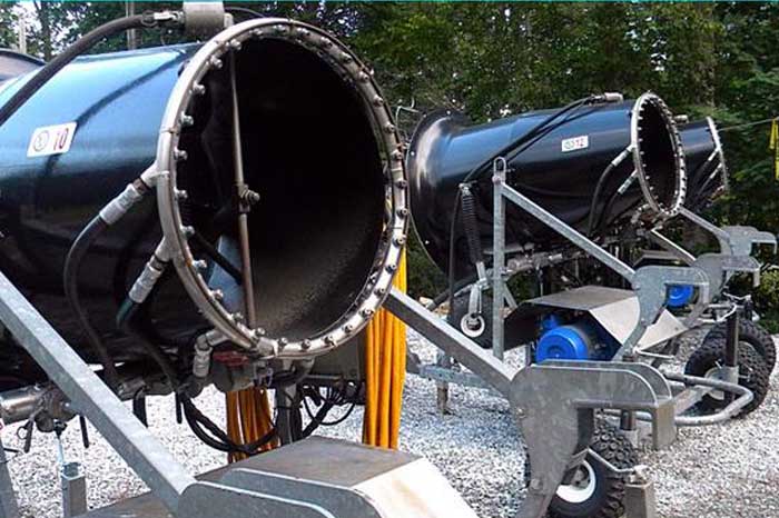 A cozy chalet overlooks Sapphire Valley in North Carolina, with a snowmobile and ski lift nearby suggesting winter activities. The ski resort is nestled against the natural backdrop of the region.