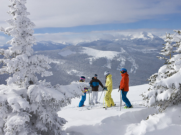 A lively winter sports scene at Sapphire Valley Ski Resort in Sapphire North Carolina USA depicting a family and group of people enjoying skiing activities amidst a snowy backdrop.
