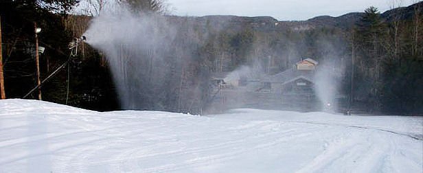 Winter scene at Sapphire Valley Ski Resort in North Carolina, featuring skiers enjoying the day on slopes and a ski lift transporting more people to the top.