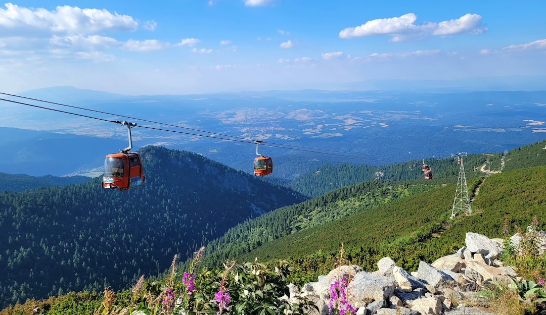 Borovets in Bulgaria - a cable car on a mountain with mountains in the background.