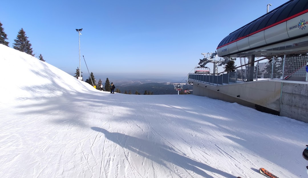 Borovets in Bulgaria - a person on a snowboard going down a hill.
