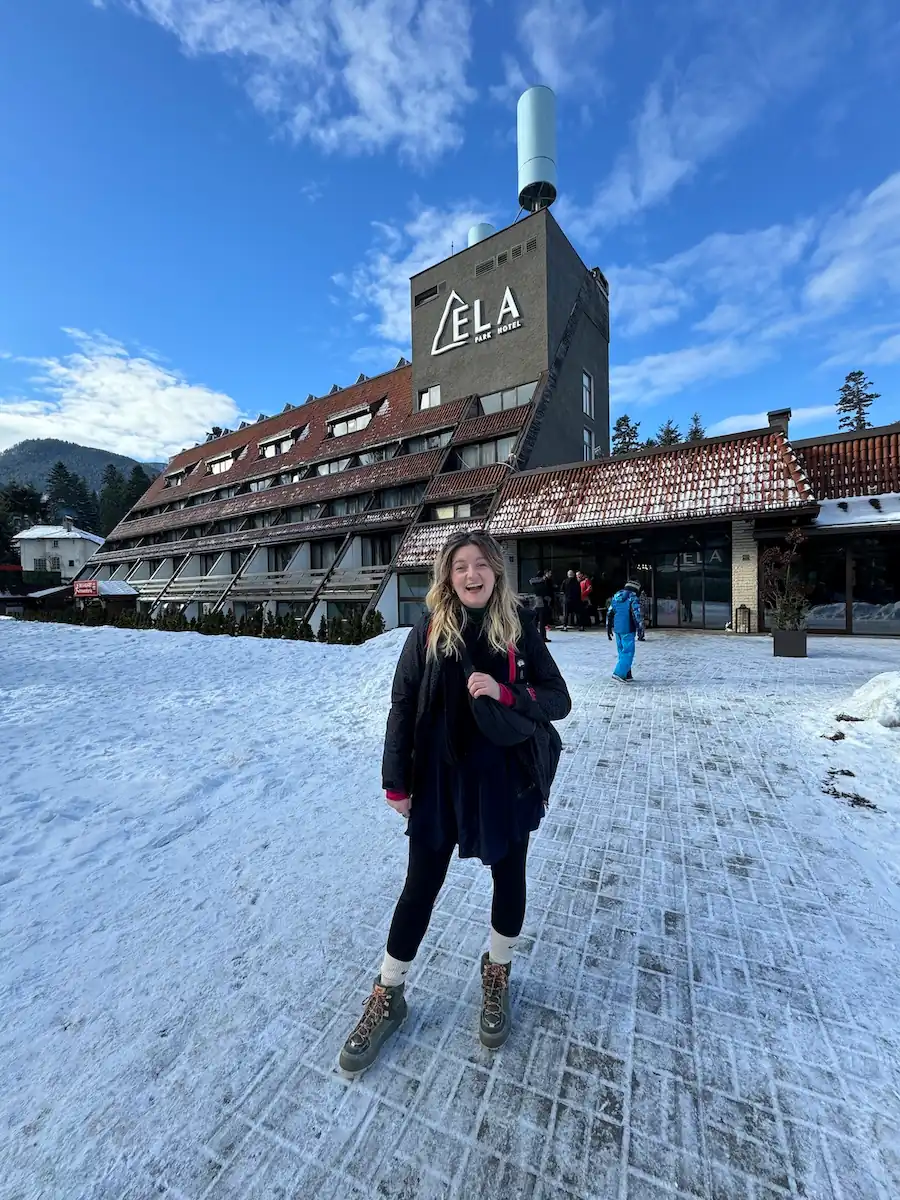 Borovets in Bulgaria: a woman standing in the snow in front of a building.