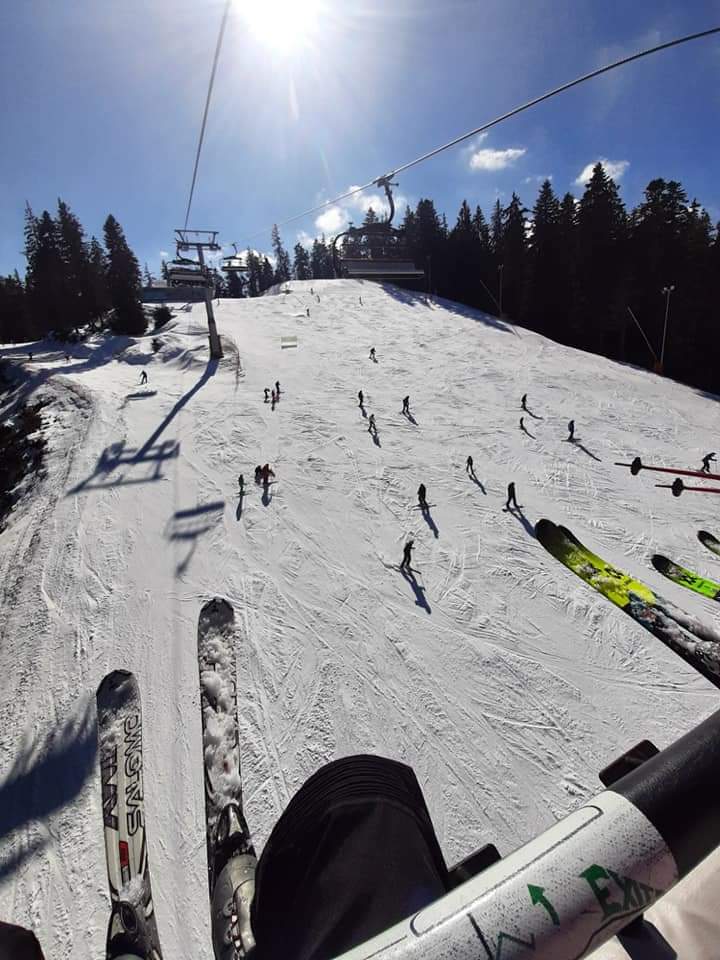 Borovets in Bulgaria - a group of people riding ski boards down a slope.