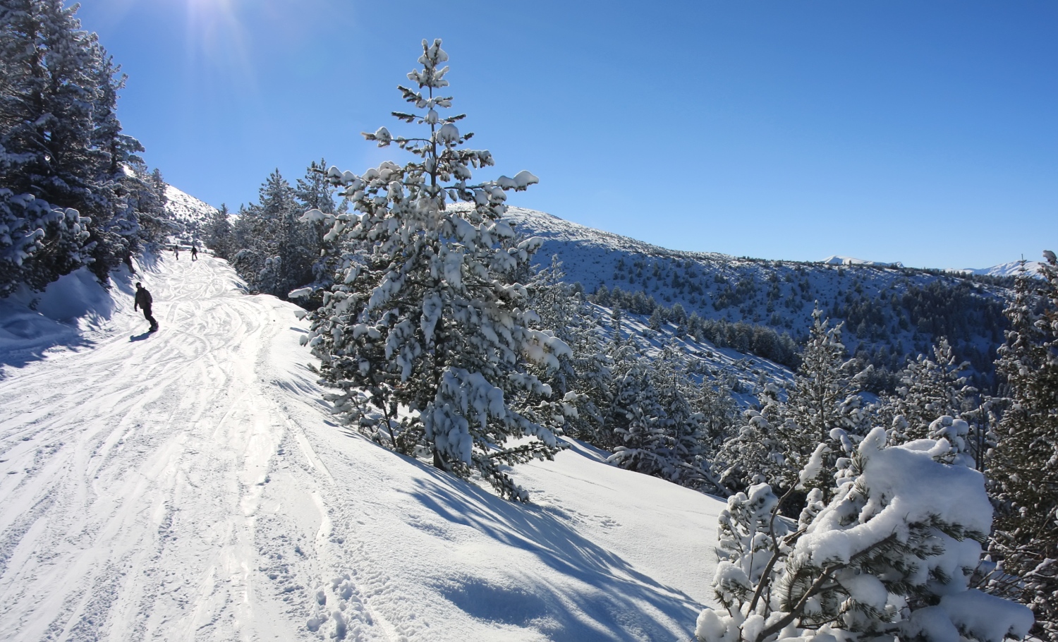 Borovets in Bulgaria - a person skiing down a snow covered mountain.