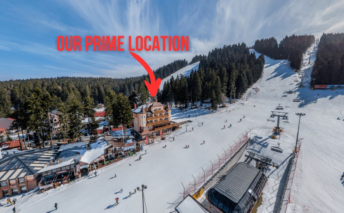 Borovets in Bulgaria - a ski slope with a red arrow pointing to the top of it.