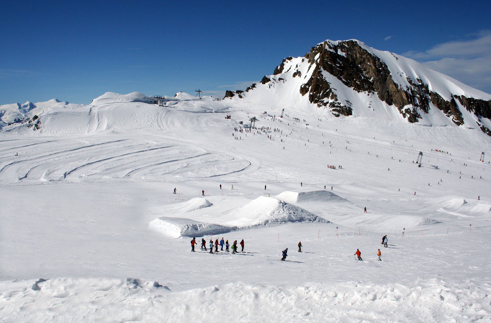 Crans Montana in Switzerland - a group of people skiing down a snowy mountain.