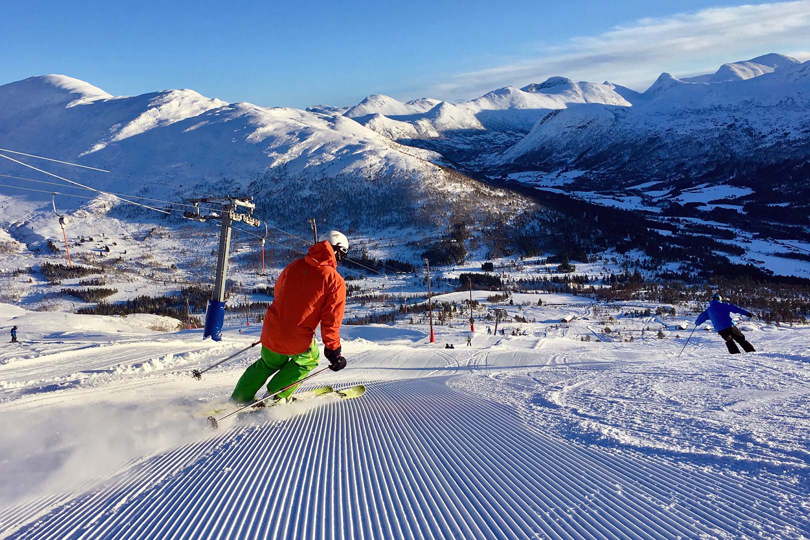 Hornindal in Norway - a person riding a snowboard down a snowy slope.