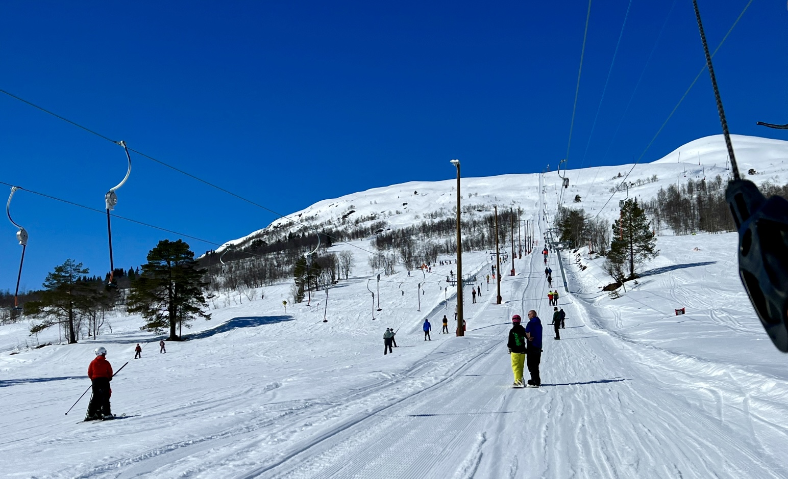 Hornindal in Norway - a group of people skiing down a snowy hill.