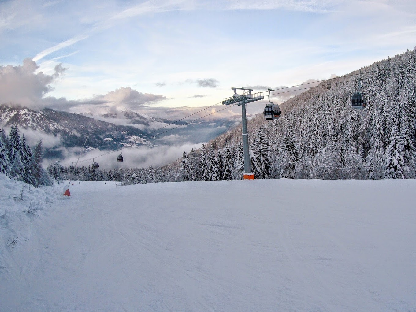 Funivie Folgarida Marilleva in Italy - a ski lift going up a snowy mountain.