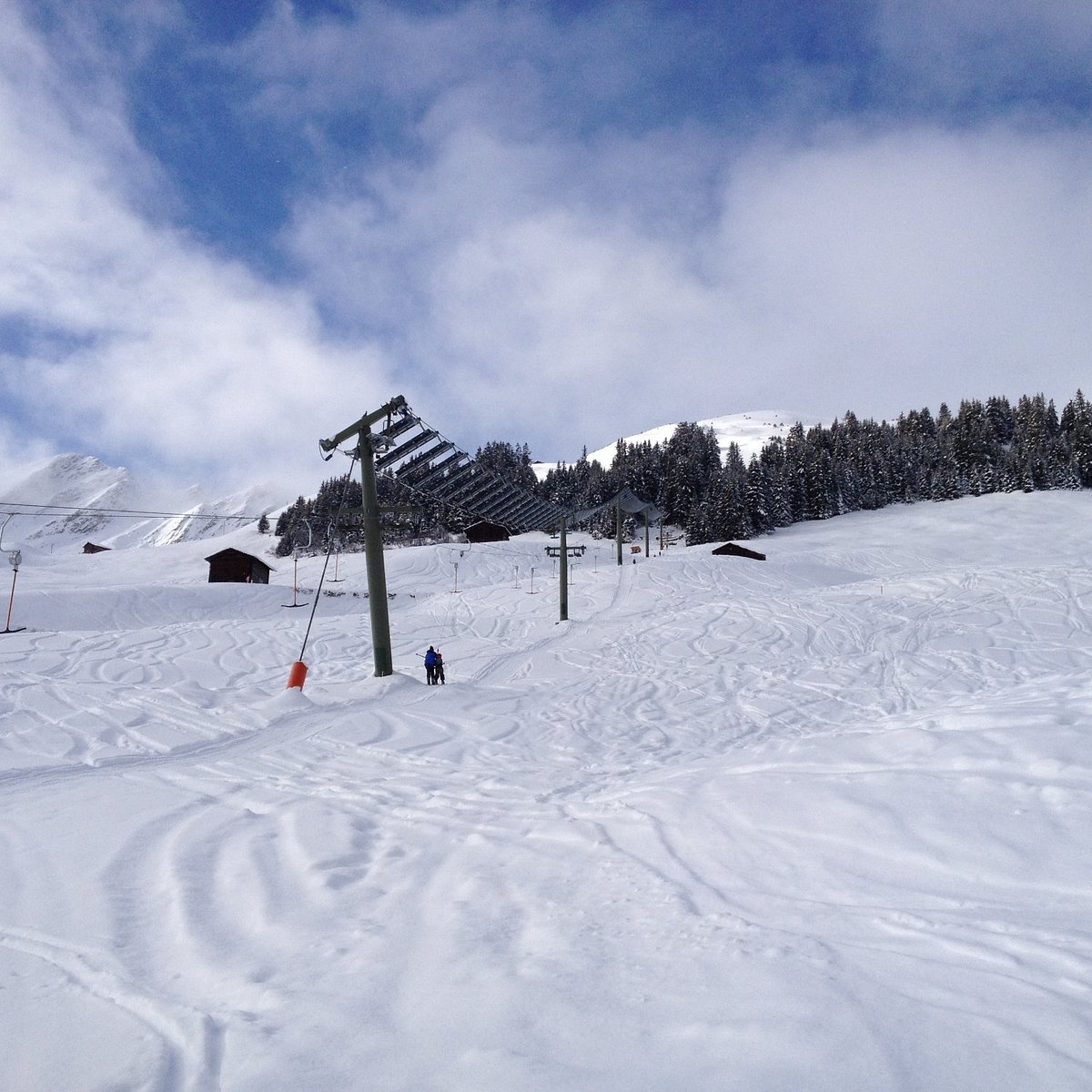 Tenna in Switzerland - a person is skiing down a snowy hill.