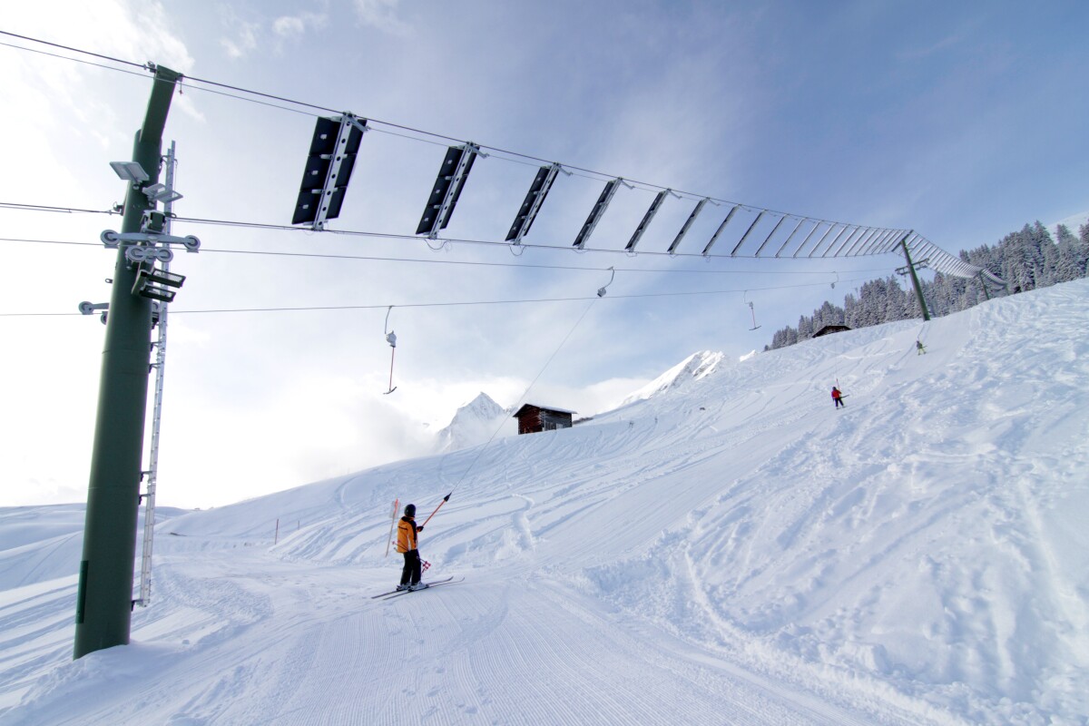 Tenna in Switzerland - a person is skiing down a snowy hill.