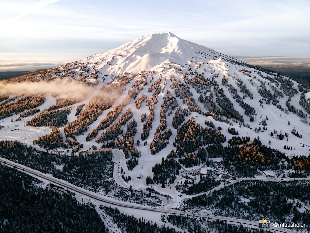 Mt Bachelor in USA - a snow covered mountain with trees in the fore.