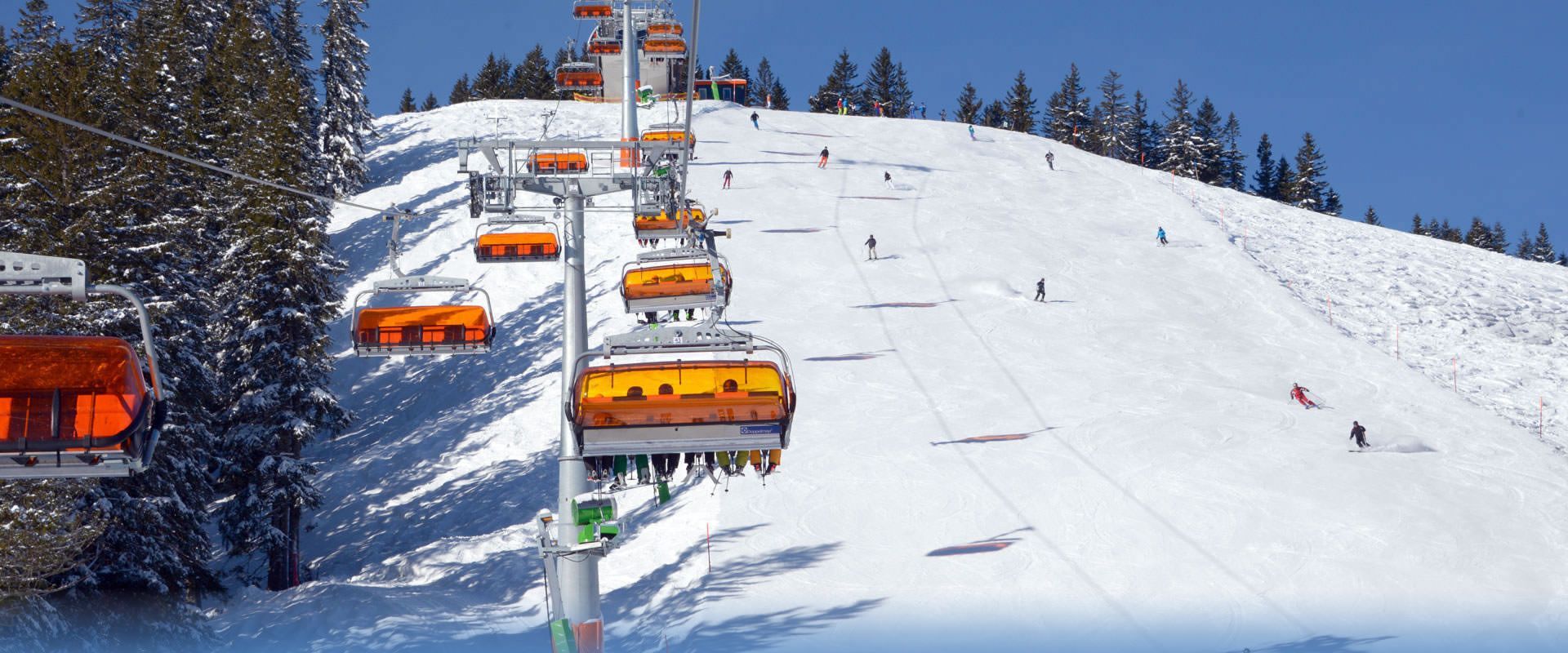 Hörnerbahn GmbH & Co. KG in Germany - a ski lift going up a snowy mountain.