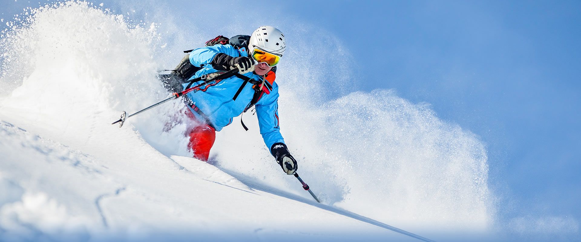 Hörnerbahn GmbH & Co. KG in Germany - a man in a blue jacket skiing down a hill.