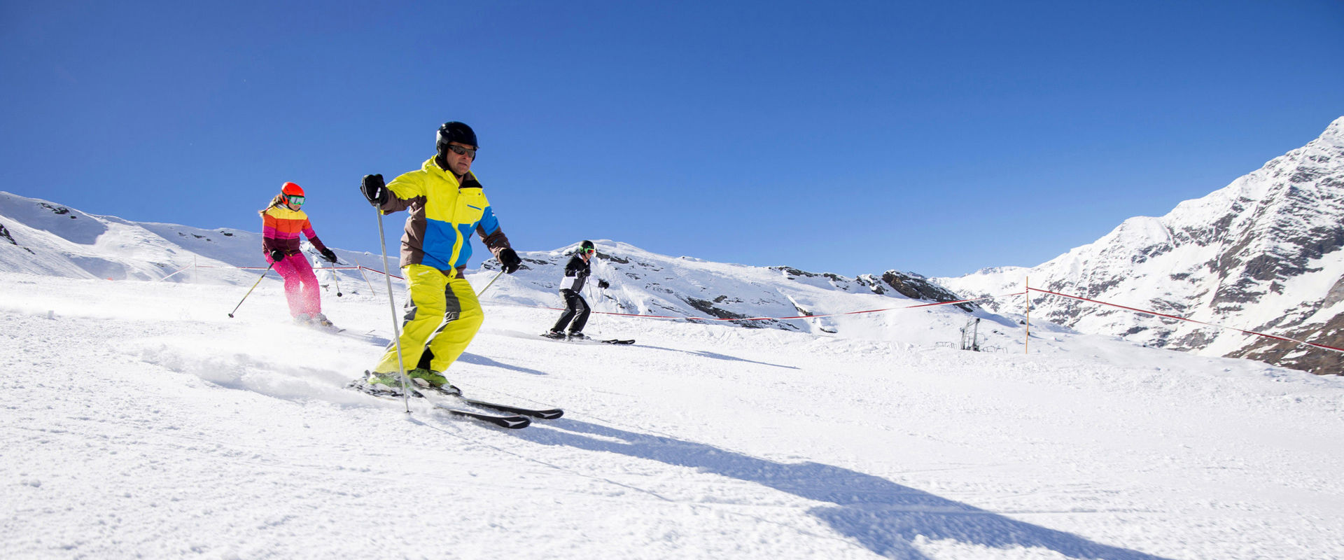 Schwemmalm in Italy - a group of people skiing down a snowy slope.