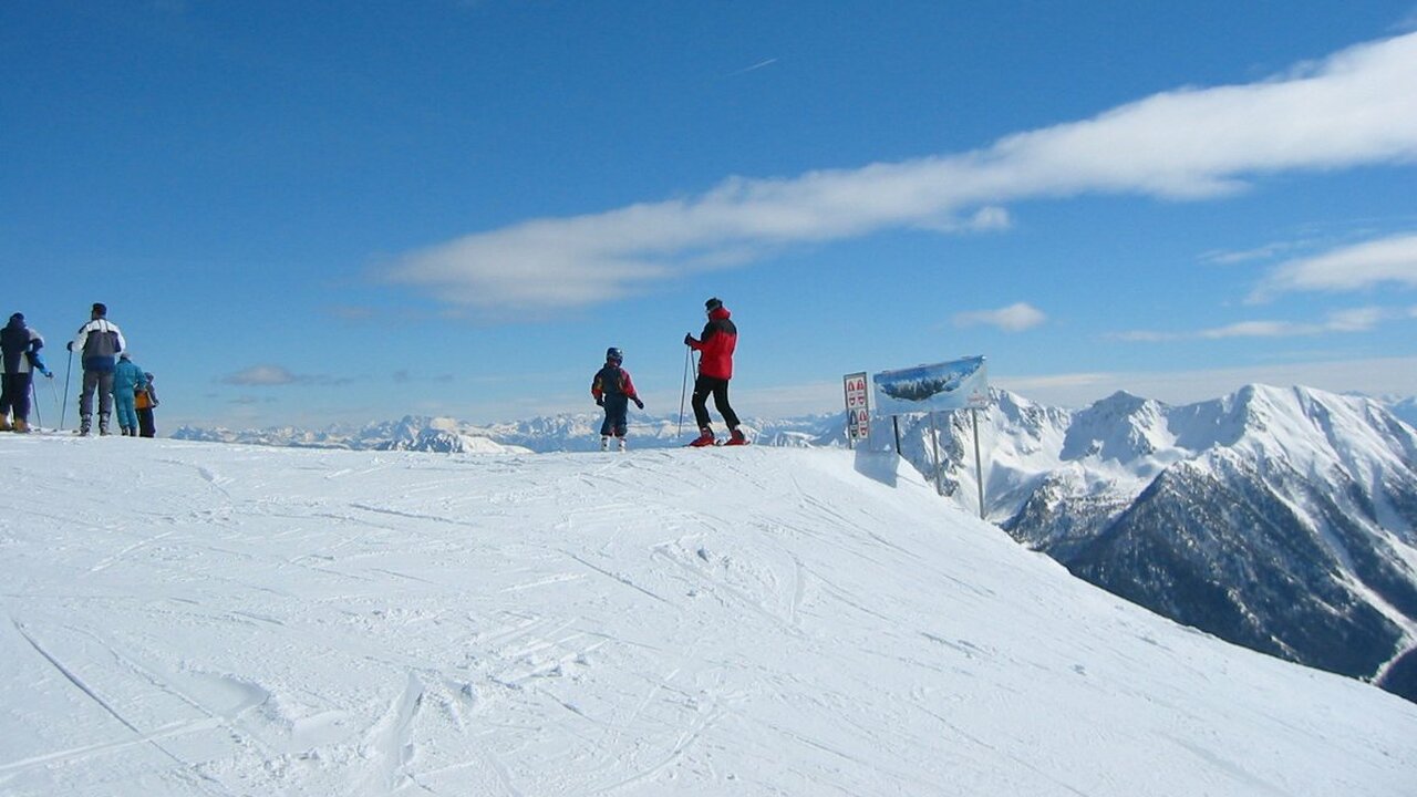 Schwemmalm in Italy - a group of people standing on top of a snowy mountain.
