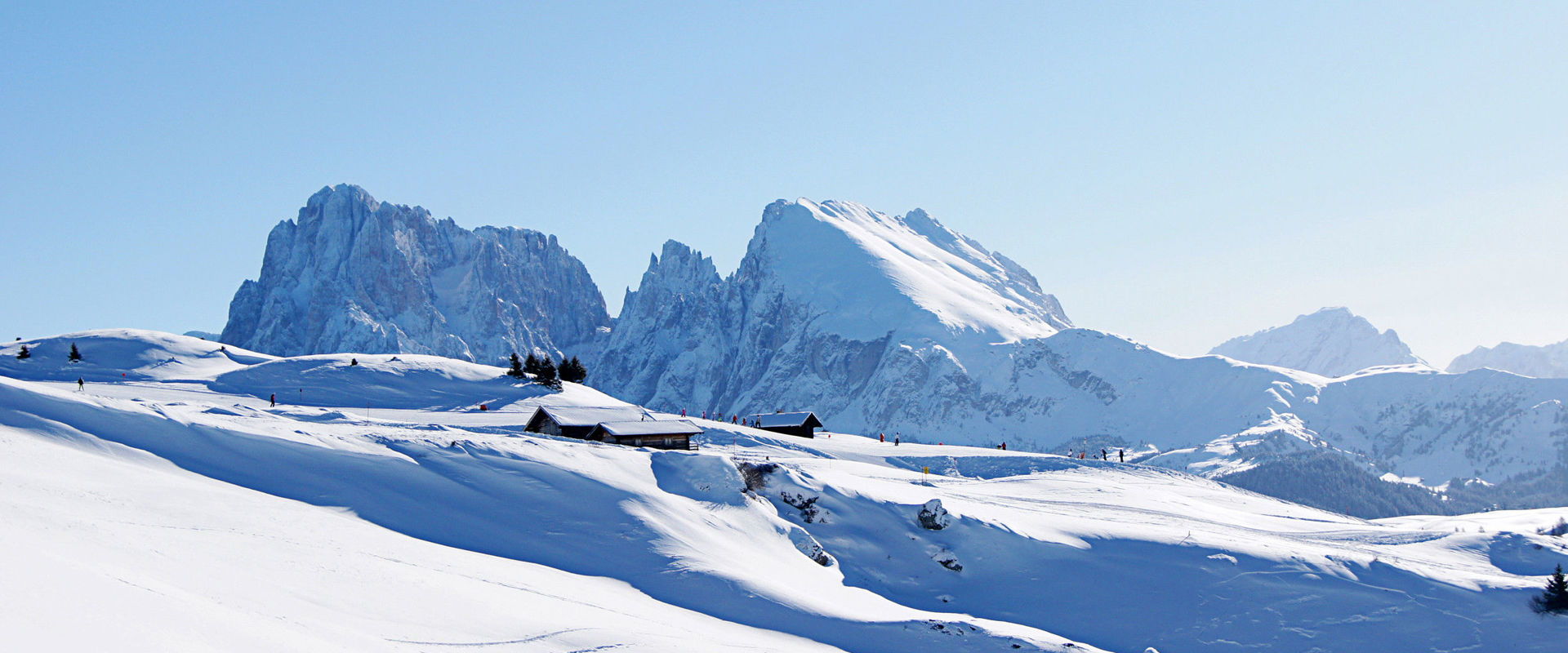 Schwemmalm in Italy - a group of people skiing down a snowy mountain.