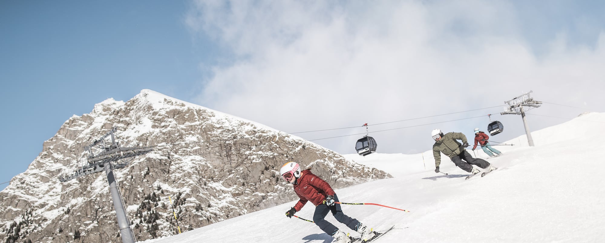 A skier enjoying a winter sports scene at Meran 2000 in South Tyrol Italy with a ski lift visible in the background at the snowy ski resort.