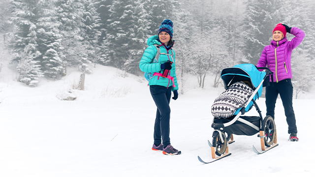 A family enjoying skiing at Isola 2000 in France, featuring a winter sports scene, with a skier and a child learning to ski. A chalet is subtly visible in the background.