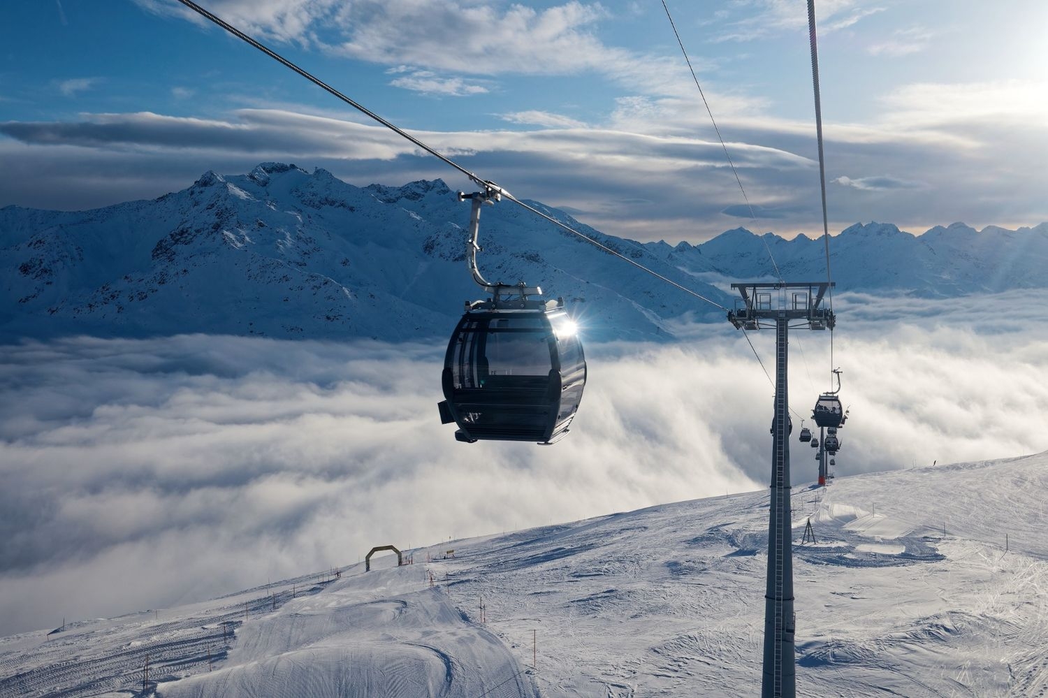Disentis in Switzerland - a ski lift going up a snowy mountain.