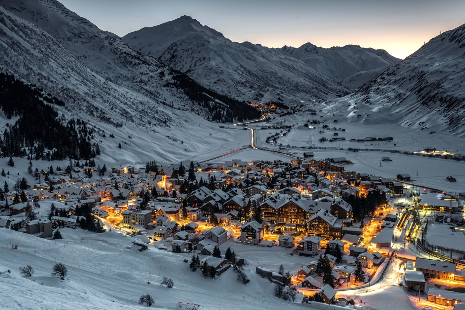 Disentis in Switzerland: a ski resort in the mountains at night.