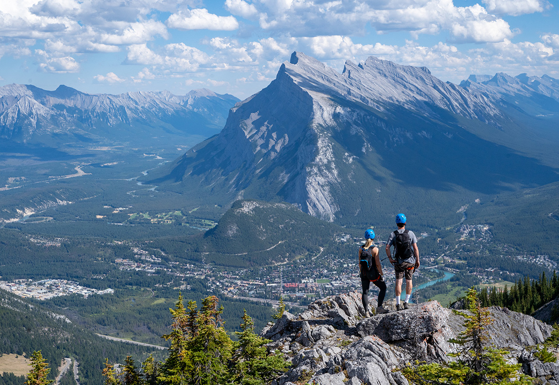 Mt Norquay – Banff in Canada - a couple of people standing on top of a mountain.