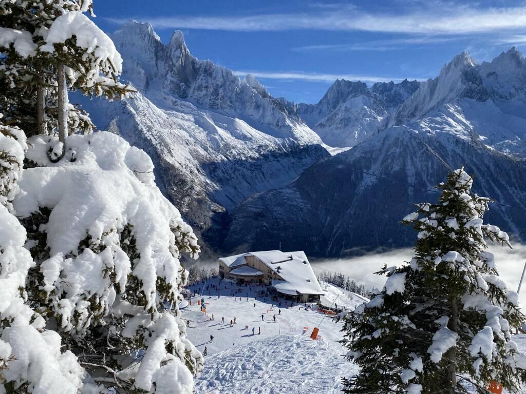 Brévent Flégère in France - snow covered trees in front of a mountain.