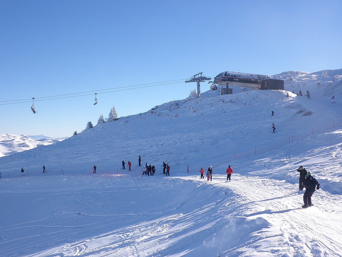 Jahorina in Bosnia and Herzegovina - a group of people skiing down a snowy slope.
