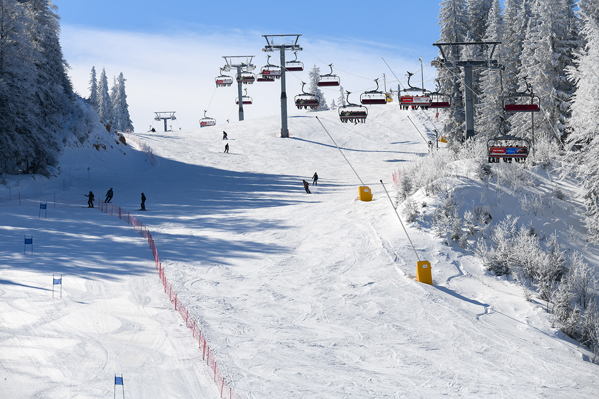 Jahorina in Bosnia and Herzegovina - a group of people skiing down a snowy slope.