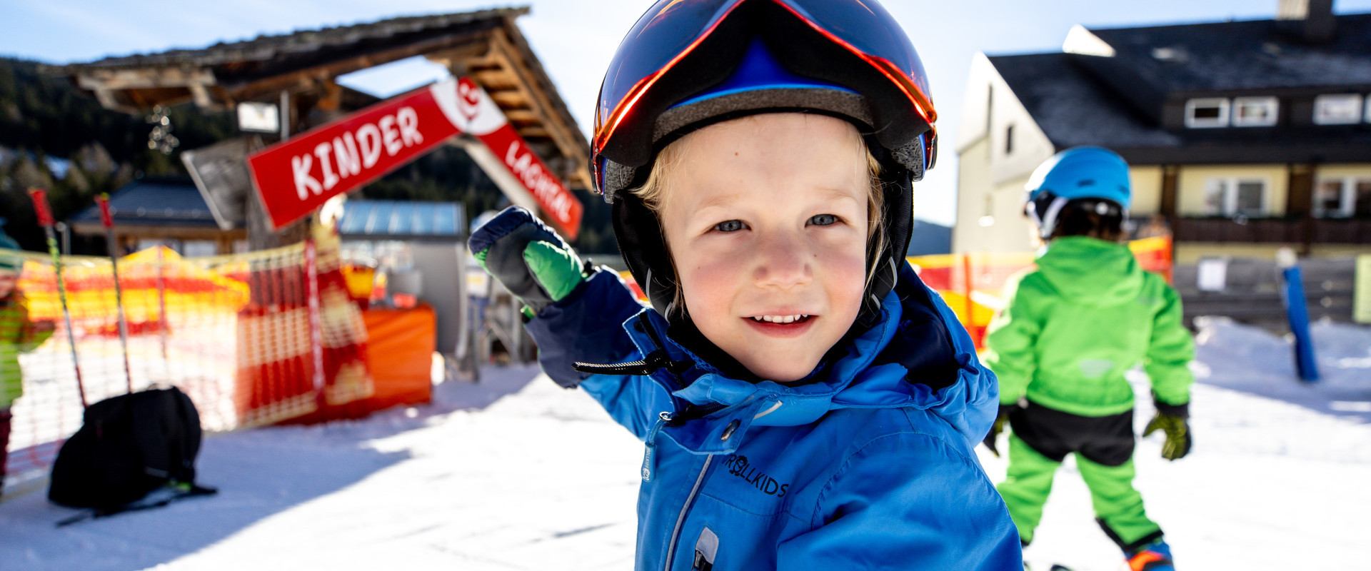 A snowboarder and a skier are enjoying the slopes at Lachtal ski resort in Murtal Styria Austria creating a typical winter sports scene.